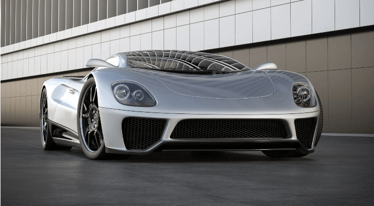 A silver car is parked in front of a building.